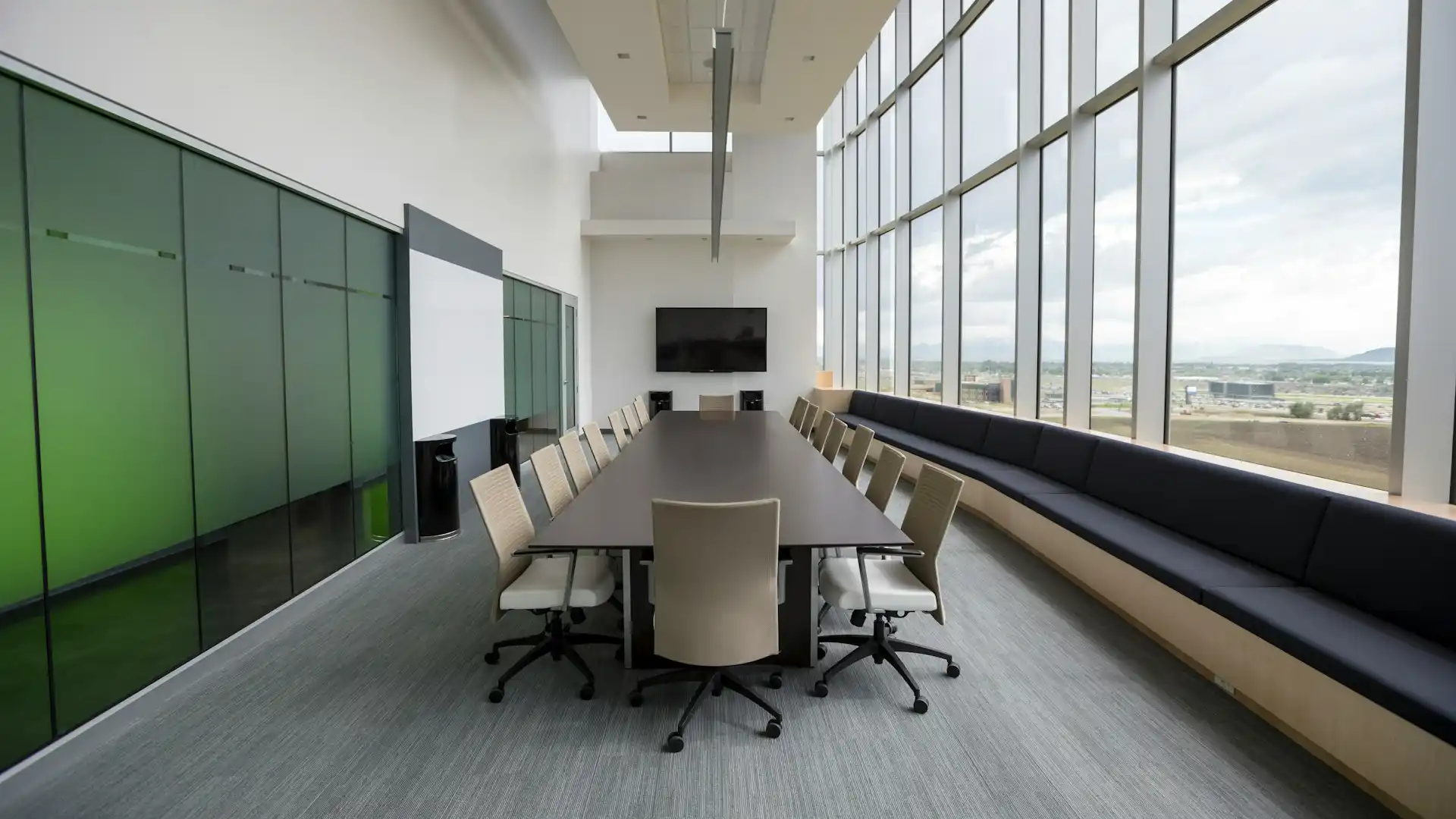 A long table in an office space with efficient lighting overhead
