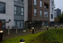Residential building at dusk with bollard lighting