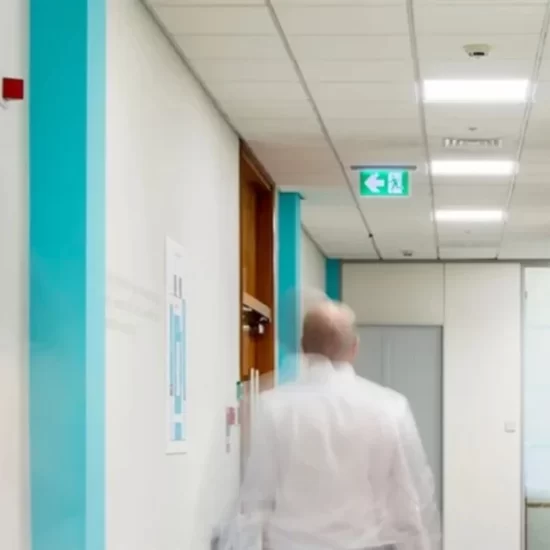 Person walks down hallway featuring an emergency drop down light