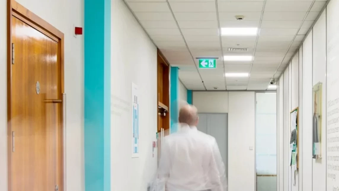 Person walks down hallway featuring an emergency drop down light