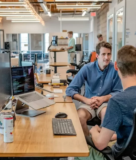 An office space with three men having a conversation