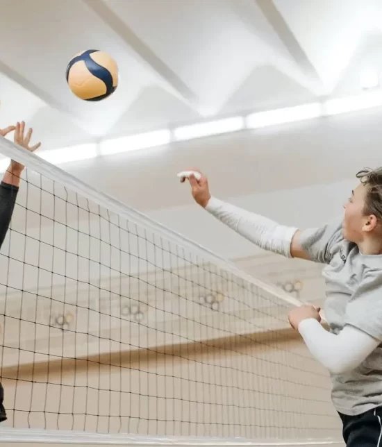 Volley ball being played in a sports hall