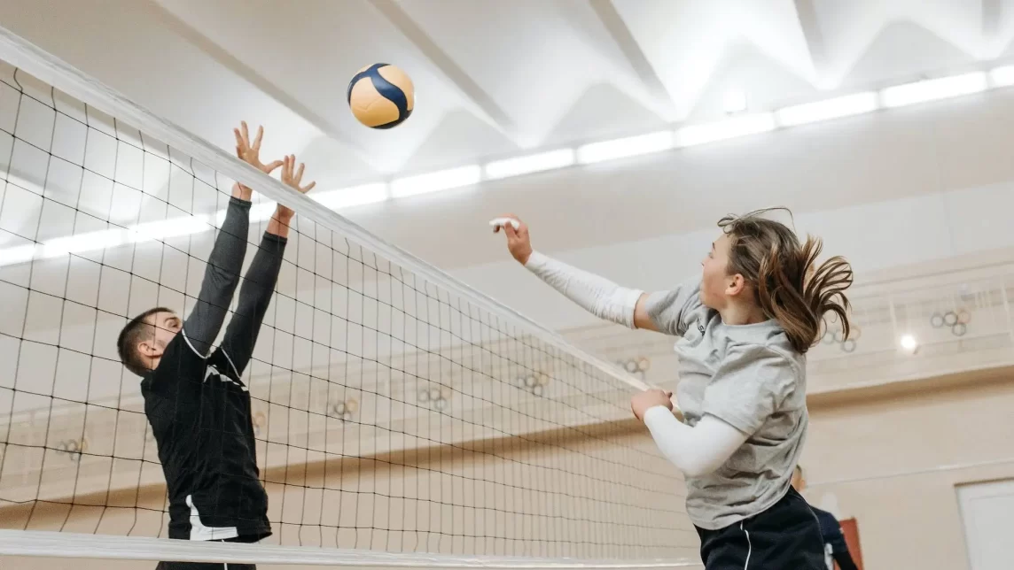 Volley ball being played in a sports hall