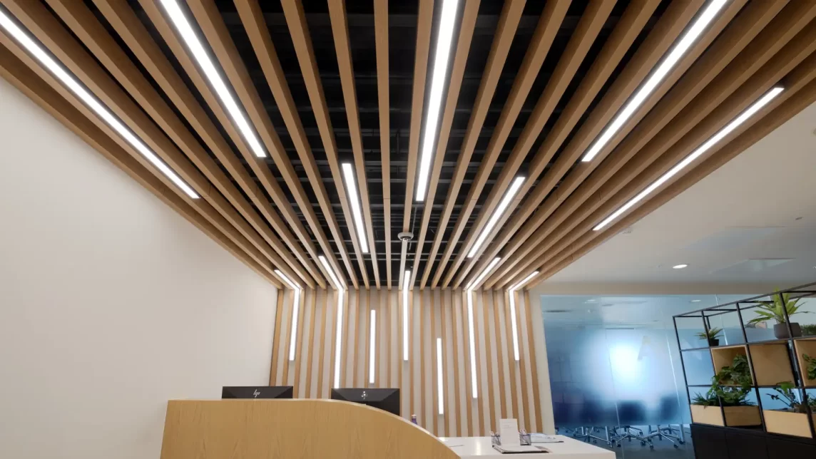Wooden reception area with signums between the slats