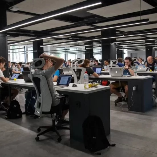 Busy office with direct overhead linear lighting