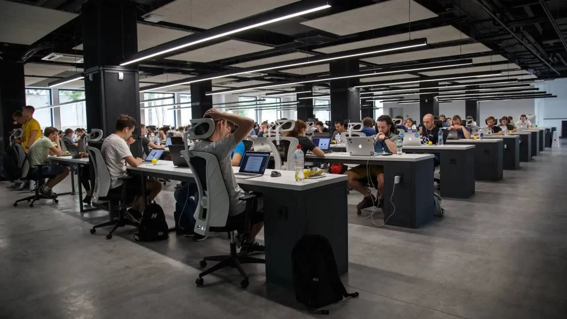Busy office with direct overhead linear lighting